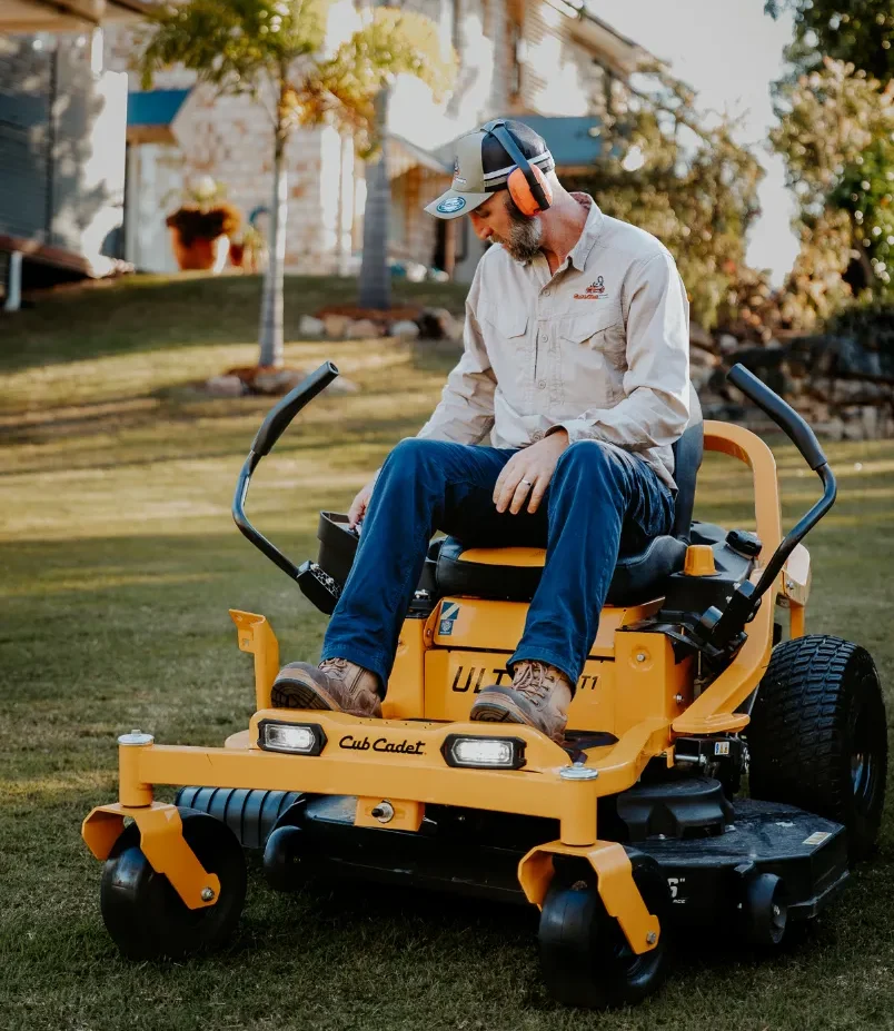 Man sitting on large yellow ride on mower